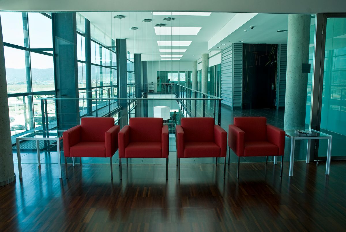 Bright branch lobby waiting area with seating, glass walls and clean polished floors