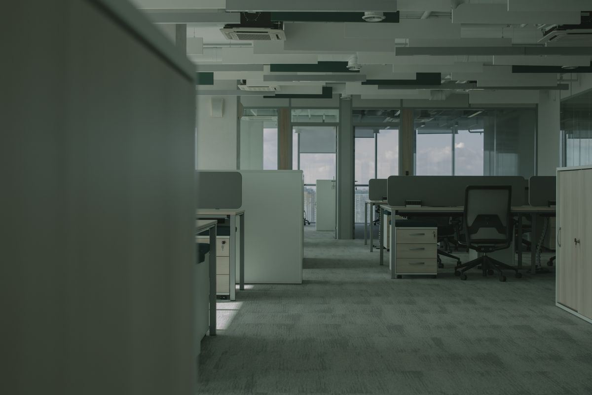 Empty office floor with workstations after tenants have moved out